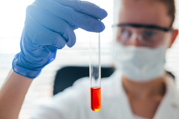 Close up of scientist checking test tube in laboratory