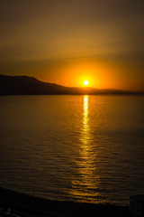 Naklejka premium Jebha sunset island and waves and rocks