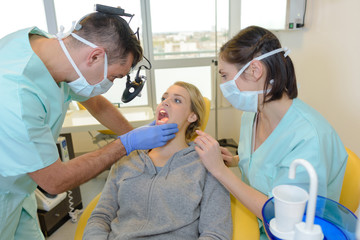 Dentist looking into patient's mouth
