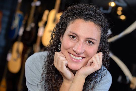 Portrait of woman, guitars in background
