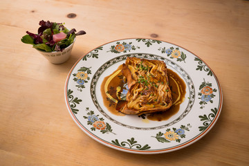 A plate of timballo pasta with a side salad.