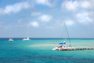 A catamaran and other boat near the shore on Isla Mujeres, Mexico.