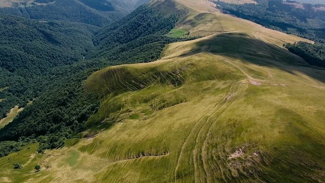 Aerial of a Carpathian range with stratified rocky beds on a sunny day in summer