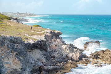 A man near a ocean-side cliff on Isla Mujeres.
