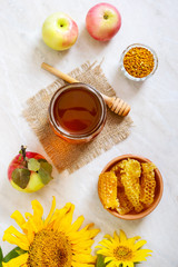 Honey in a glass jar, honeycomb, pollen. Products of beekeeping. The concept of healthy eating. Honey theme.