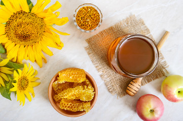 Honey in a glass jar, honeycomb, pollen. Products of beekeeping. The concept of healthy eating. Honey theme.