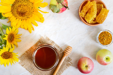 Honey in a glass jar, honeycomb, pollen. Products of beekeeping. The concept of healthy eating. Honey theme.