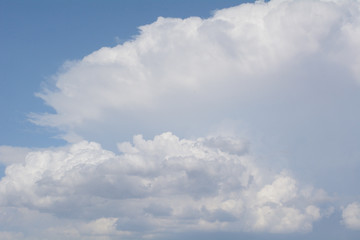 Early summer afternoon buildup of clouds with movement off Rocky Mountains as clouds move eastward over prairie to form storms over Eastern Colorado and Kansas
