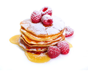 Pancakes with raspberries and honey or maple syrup. Isolated on white background