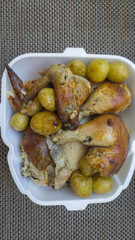 Delicious roasted chicken, ready for meal, still packed in styrofoam box. Typical dish of the Brazilian weekends, usually delivered by bakeries or restaurants.