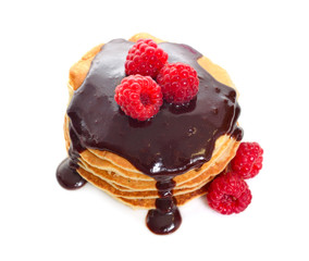 Pancakes with raspberries and chocolate sauce. Isolated on white background