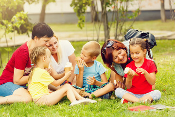 Family with kids eating ice-cream. Outdoor.