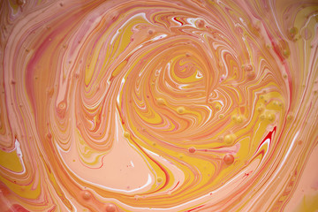 Photos of manufacturing a paint composite color. Mixing acrylic paint in different colors. Marbleized.