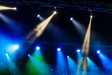A smartphone held with two hand in order to shoot a footage during a concert.