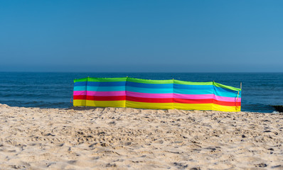 Fototapeta na wymiar Beach screen on the Polish beach on a sunny summer day in the background beautiful sea.