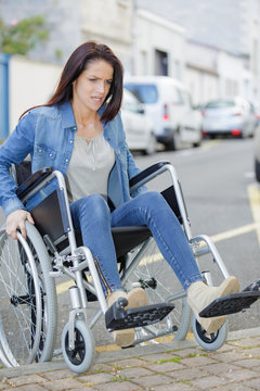 disabled woman trying hard to move in the city