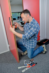 man fixing a door