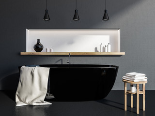 Gray bathroom interior, black tub