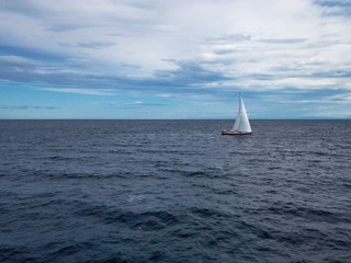 Obraz premium Sailing Boat in the sea with bright blue sky