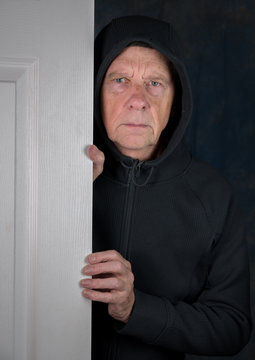 Senior caucasian man greeting visitor at doorway