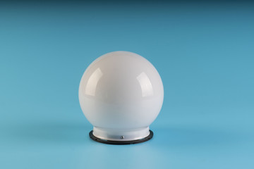 white round lamp isolated on blue background