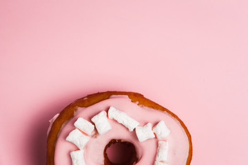 Pink donut with marshmallows on a Pink background