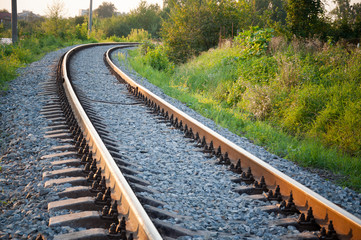 Obraz premium railway tracks lead to the station on a summer