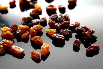 Raisins background / A raisin is a dried grape. Raisins are produced in many regions of the world and may be eaten raw or used in cooking, baking, and brewing.
