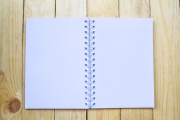 Open notebook on wooden background.