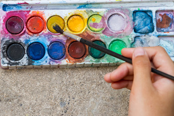 Mix paint with a paintbrush