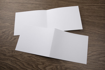 Mockup of white booklet on wooden background.