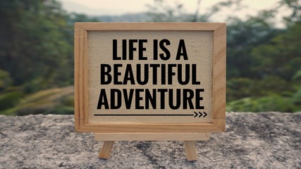 Motivational and inspirational quote - ‘Life is a beautiful adventure’ written on a whiteboard....