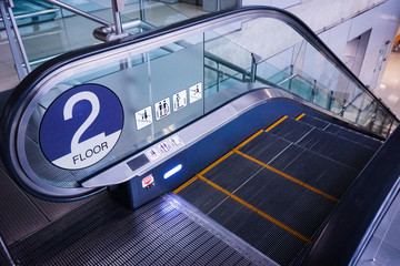 Escalator in underground. electric escalator.. yellow bands. metal line steel. yellow gray steel line