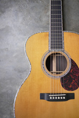 Obraz premium Detail of classic guitar on concrete background with shallow depth of field.