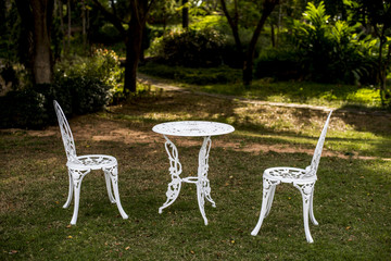 white chair and table in garden. English vintage style