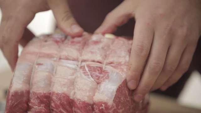Man cuts holes in prime rib and stuffs with garlic