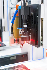 Robot holding glue syringe Injection with robotic machine vision system