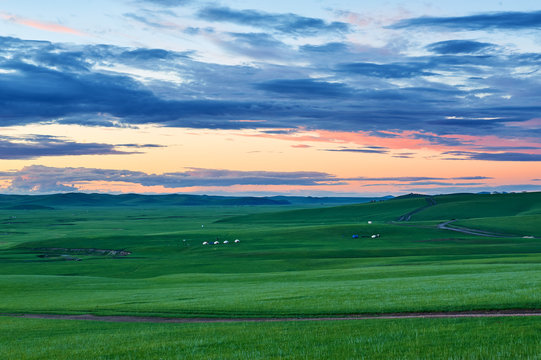 The Mongolian Yurts In Summer Grassland Sunrise.