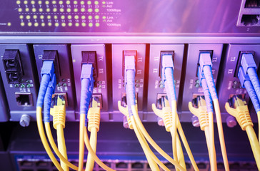 Fiber Optic cables connected to an optic ports and Network cables connected to ethernet ports