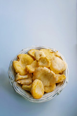 Closeup of a healthy chanterelle in a basket on a white background