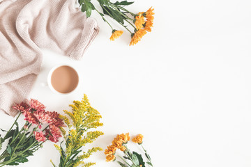 Autumn composition. Cup of coffee, fresh flowers on white background. Autumn, fall concept. Flat...