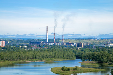 Naklejka premium The factory emits dirty smoke from the pipes