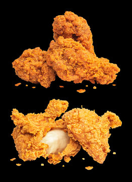 Fried chickens isolated on dark background. Deep fried of crispy fast food.