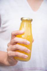 Juice in bottle in woman hand