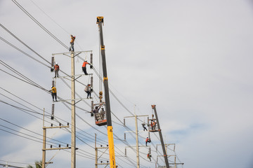 worker are installing electricity poles.