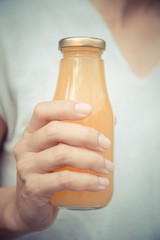 Juice in bottle in woman hand