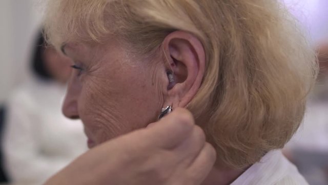 Adult woman with a hearing aid