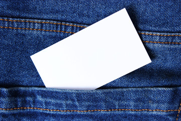Business card near the pocket of jeans.