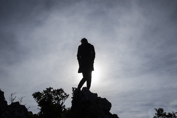 Woman Silhouette at sunrise on rock