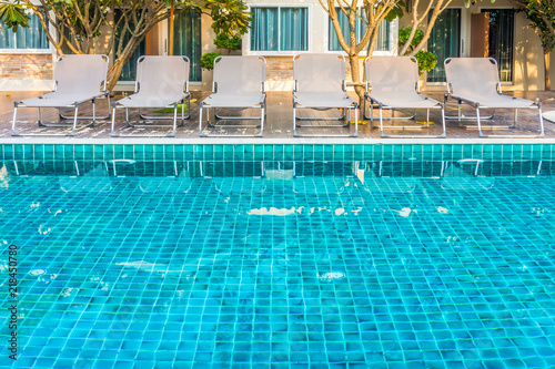Sun Loungers On Decks At Waterfront Of A Side Of Swimming